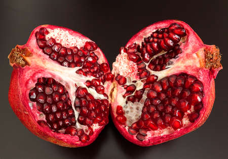 pomegranate fruit cut on halfの写真素材
