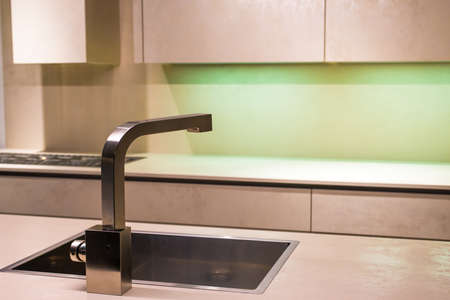 Contemporary Stainless Steel Tap in Minimalist Kitchenの写真素材