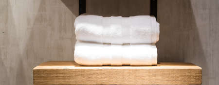 Two Fluffy White Towels on Bathroom Shelf