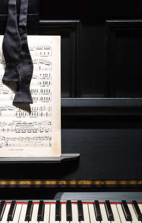 Black Piano with Sheet Music and Bow Tie