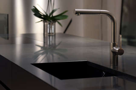 Dark Solid Granite Sink with Modern Stainless Steel Faucet Tapの写真素材