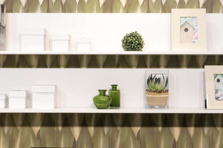 White Shelves with Various Stylish Items on Green Dated Wallpaperの写真素材