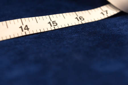 Tailor's White Tape Measure on Dark Blue Velvet Clothの写真素材