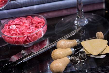 Tailor's Table with Assorted Implements including awl, thimbles, buttons and chalk