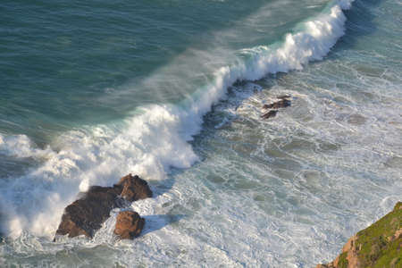 Sea and ocean foam, beautiful waves, rocks, blue water from Portugal