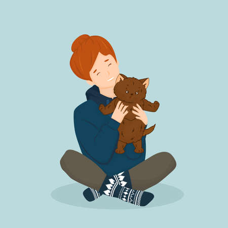 Red girl in hoodie and knitted christmas blue socks holds cute fluffy brown cat or kitten. Isolated cartoon hand drawn picture, blue backgroundのイラスト素材