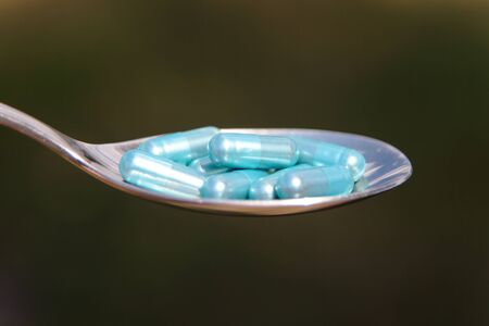 Natural vitamins in a spoonの写真素材