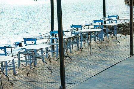 the seafront promenade in the evening with an empty cafe