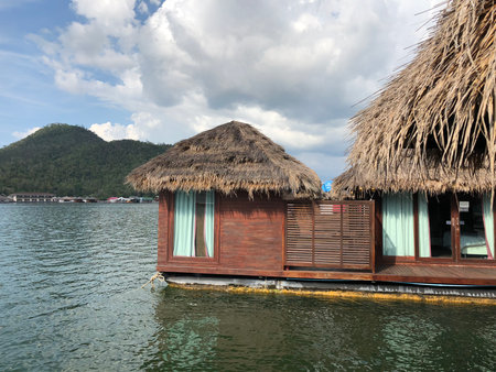 Floating room on calm water in Kanchanaburi resort, Thailandの写真素材