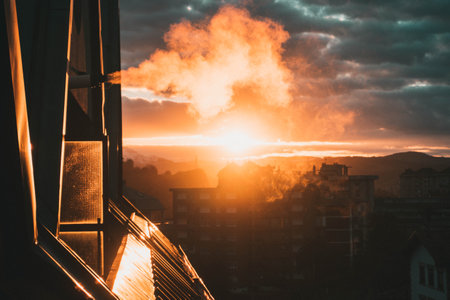 Beatiful smoke vent, on the roof of a flat because of the gas heating on a cold day with a spectacular sunset. Natural vent expel smoke outside using the exhaust pipe.の写真素材