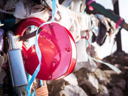 Pink heart lock on a fenceの写真素材