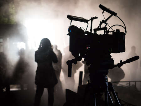 Silhouette of a professional movie camera in the dark on the set.の写真素材