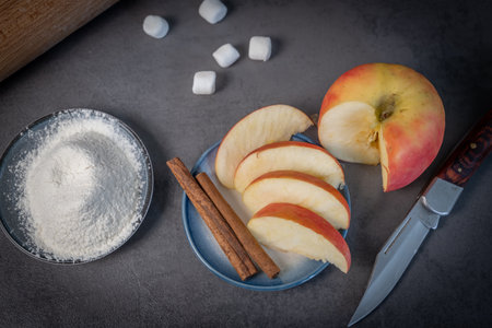 cut apples and cinnamon stick for pastry repairの写真素材