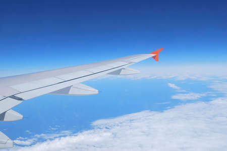 Flight over white clouds in the blueの写真素材