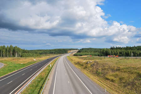 Roads and  highways of Finland  surrounded by green forests  の写真素材