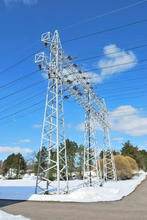 Electricity transmission lines  pylons on the  background of blue sky の写真素材