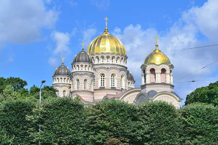 Riga, Latvia. Very beautiful Orthodox cathedral surrounded by trees in a sunny summer dayの写真素材