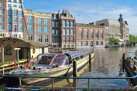 Amsterdam, Netherlands. Beautiful old buildings on the bank of the Amstel River in the Old Townの写真素材