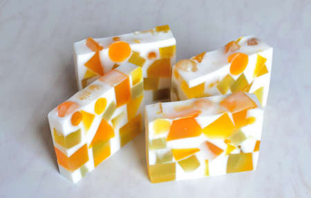 Four pieces of original handmade soap with splashes of geometric shapesの写真素材