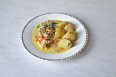 Homemade food. Pollock in creamy carrot sauceの写真素材