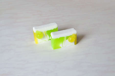 Two pieces of beautiful handmade apple soap, decorated with small applesの写真素材