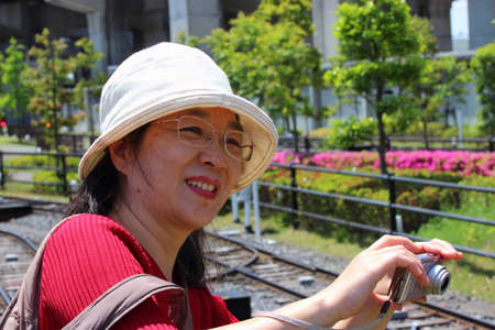 Omiya, Japan - May 11, 2014  Smiling Asian woman taking pictures with your compact camera のeditorial素材