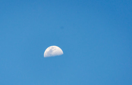 crescent moon in the blue sky, photographed from the equatorial lineの写真素材