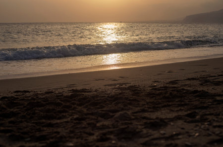 Photography of the coastline, the sea and sand, during the sunsetの写真素材