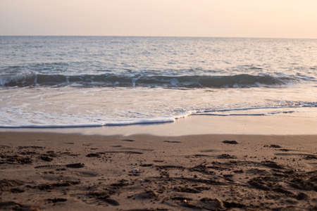Photography of the coastline, the sea and sand, during the sunsetの写真素材