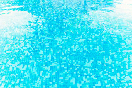 Photography of a swimming pool water surface, clear and blue natural water with sparkling reflections.の写真素材