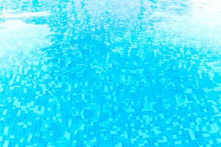 Photography of a swimming pool water surface, clear and blue natural water with sparkling reflections.の写真素材