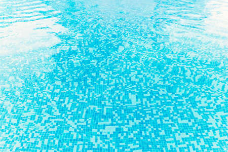 Photography of a swimming pool water surface, clear and blue natural water with sparkling reflections.の写真素材