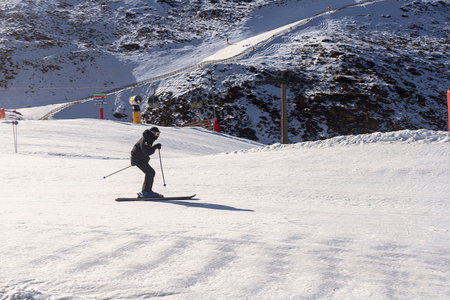 Person snowboarding the snowy mountain of Sierra Nevada, Granada, during the winter.の写真素材