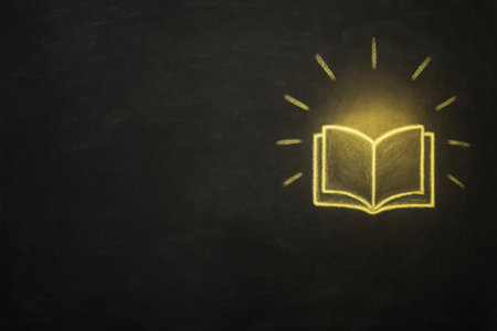 High-resolution stock photo of a blackboard with a chalk drawing of an open yellow book. Concept image representing education, learning, and knowledge. Minimal style with wide copy space for school, academic, or business text and branding.の素材