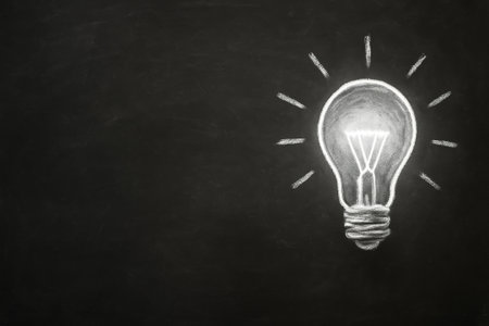 High-resolution stock photo of a blackboard with a chalk drawing of a glowing white light bulb. Concept image representing ideas, creativity, innovation, and inspiration. Minimal professional composition with wide copy space for business, education, or motivational text and branding.の素材