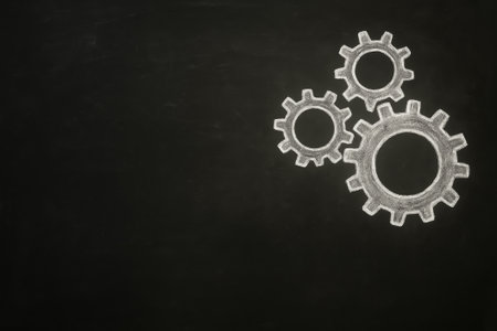High-resolution stock photo of a blackboard with chalk-drawn gears white color. Concept image representing teamwork, collaboration, productivity, and efficiency. Minimal composition with large copy space for business, educational, or motivational text and branding.の素材