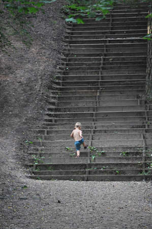A boy climbing upstairsの写真素材