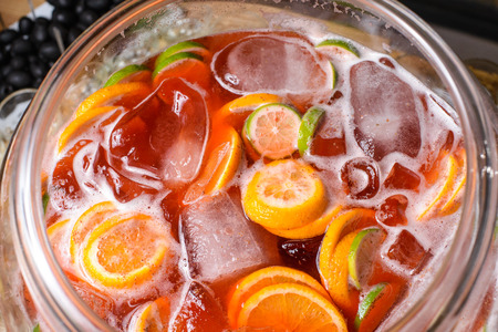 Cold fruit punch of orange, lime and champagne with iceの写真素材