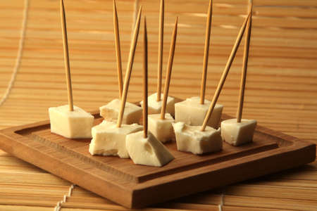 pieces of white cheese on a wooden boardの写真素材