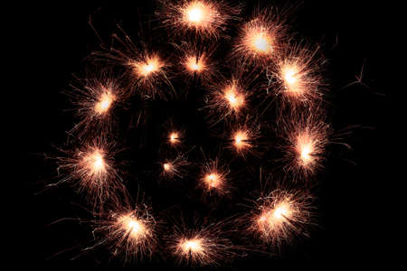 sparkler spiral isolated on black backgroundの写真素材