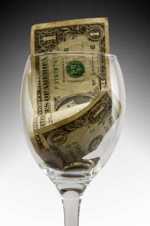 tip in a glass with moneyの写真素材