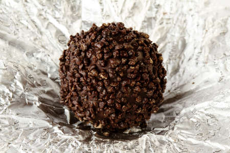 round chocolate candy on foil wrapping