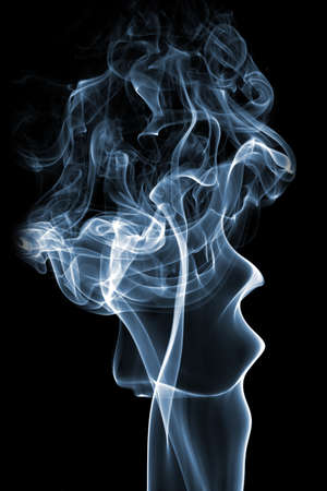 blue aromatic stick smoke figure on black backgroundの写真素材