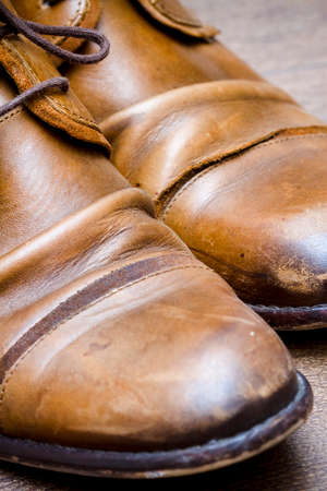 Brown leather shoes on the wooden floorの写真素材