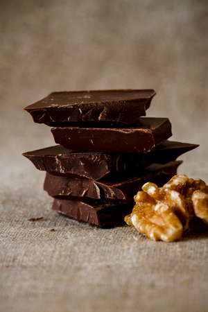 Chopped chocolate with several wallnuts on cotton mapの写真素材