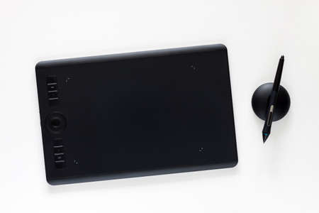 Graphic tablet on a white empty background. Computer graphics desk.の写真素材