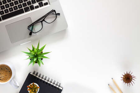 Office desk with a laptop. Coffee and office supplies. Copy space.の写真素材