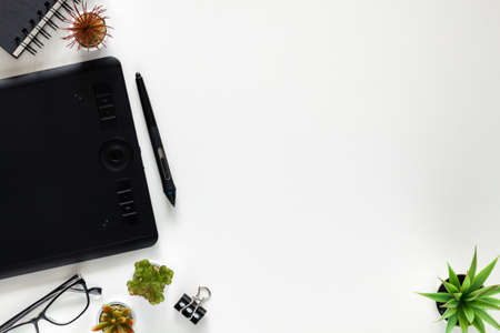 White office desk with graphic tablet. Office supplies. Copy space.の写真素材