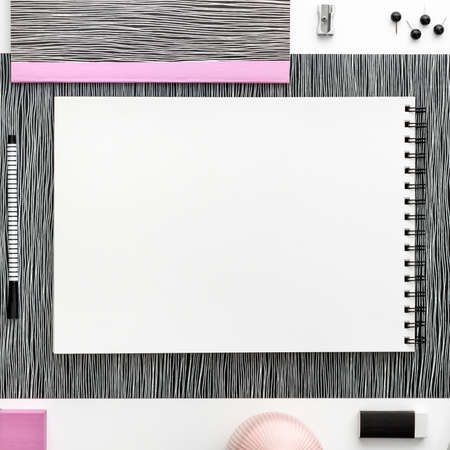 Open notebook or sketchbook  with white blank page. Ideas, notes, plan writing or sketching concept. Top view mockup. Pastel pink office elementsの写真素材