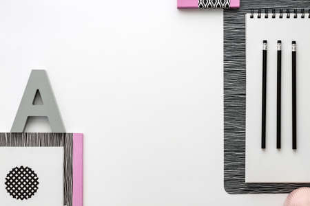 Office table top view with white space for your text. Black and white concept with pastel pink...